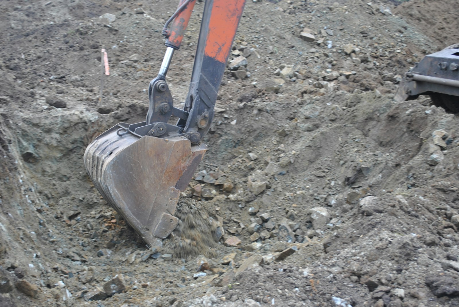 a bulldozer digging through a pile of dirt